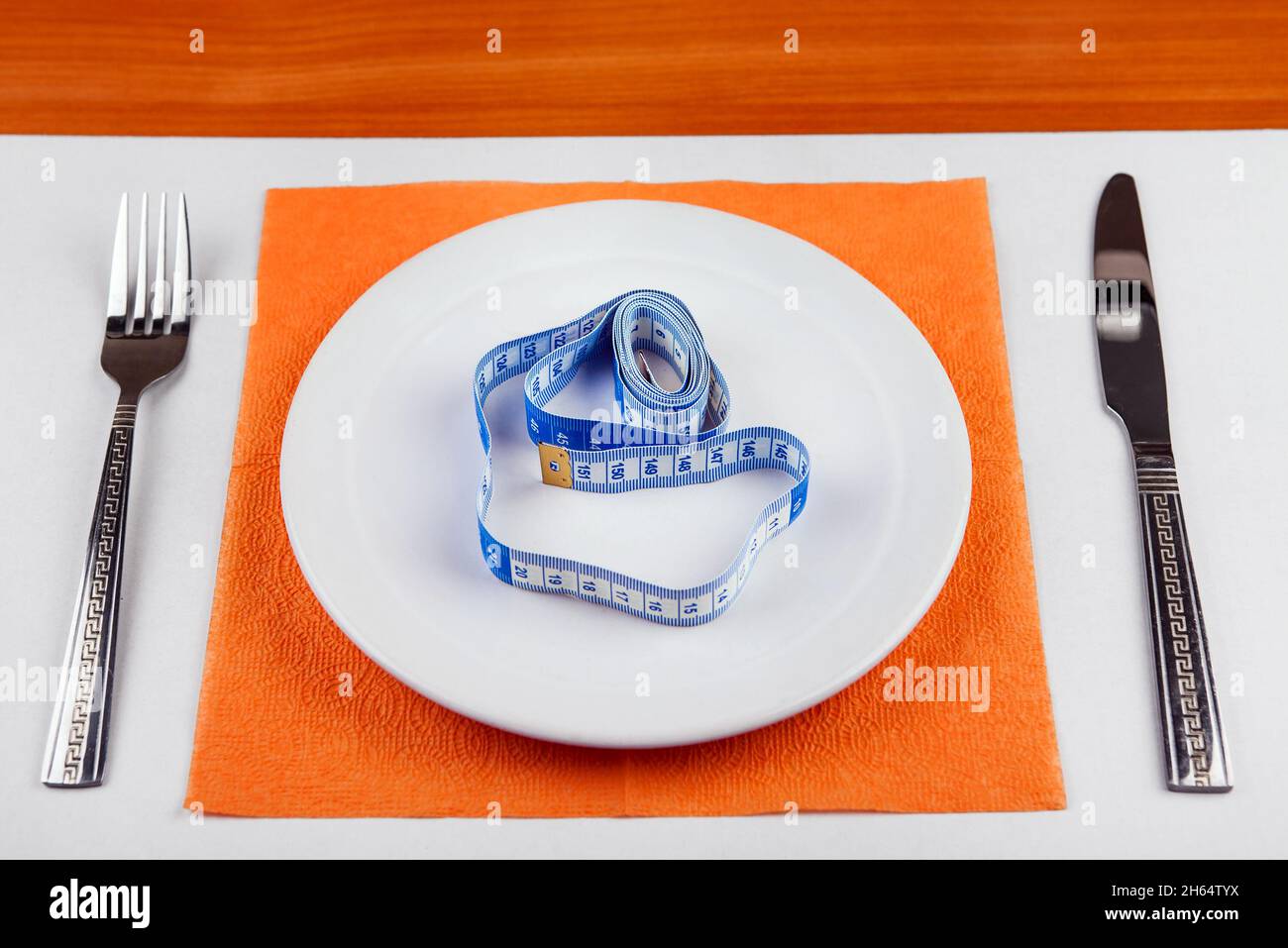 Tape Measure in the Plate on the Table Stock Photo