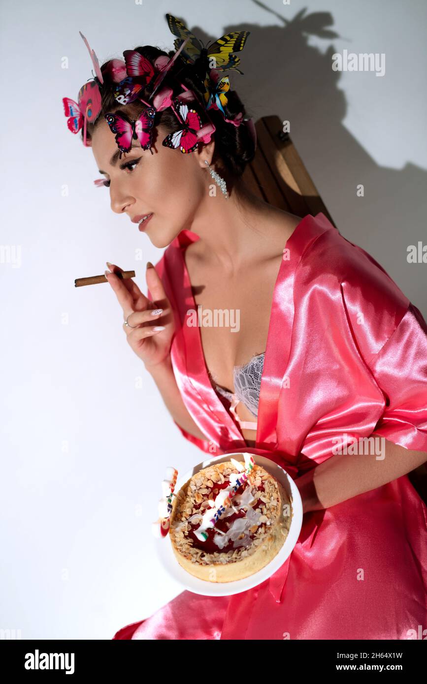 Young woman in lingerie with birthday cake Stock Photo