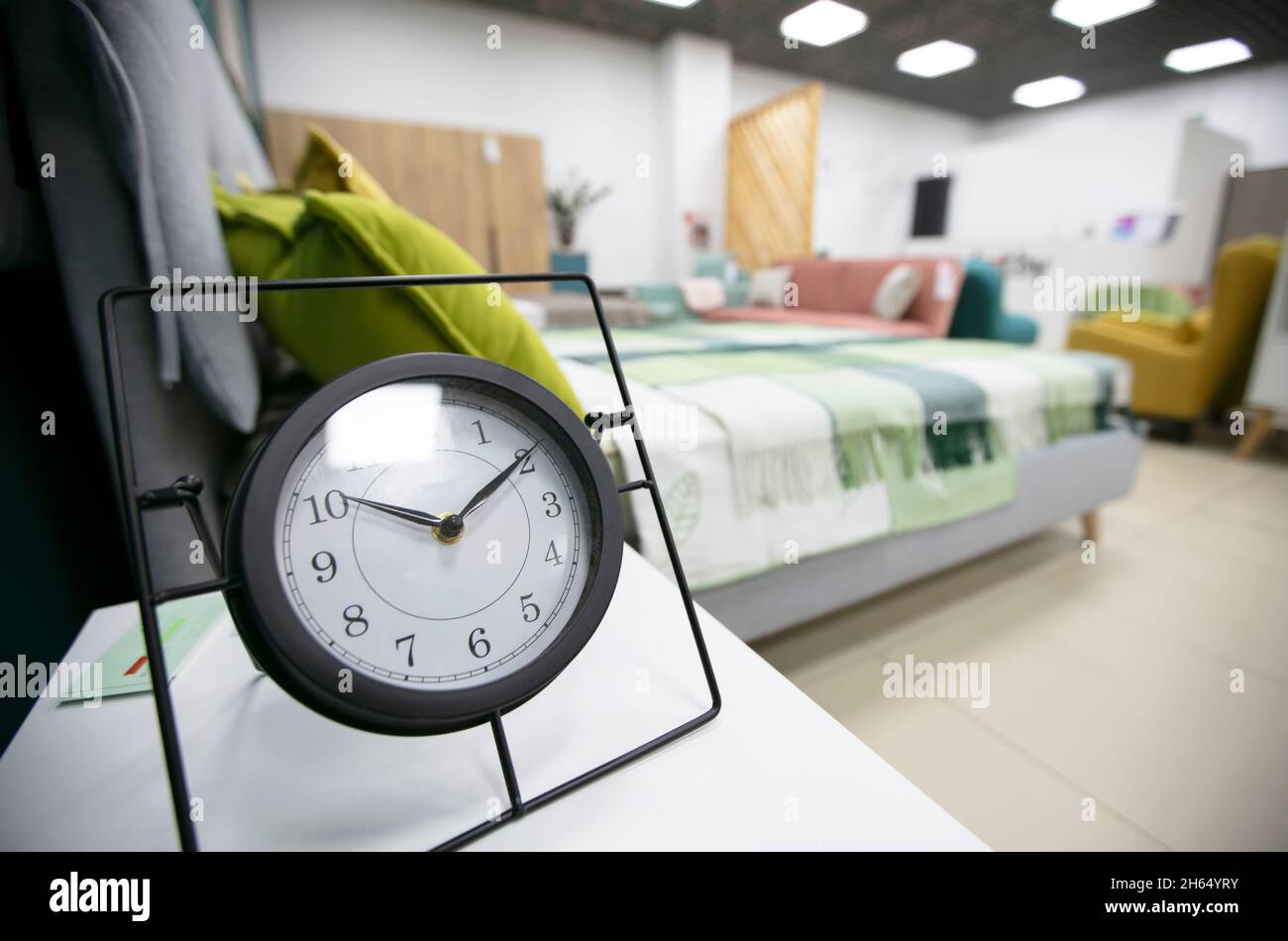 Alarm clock on the table in the bedroom. Stock Photo