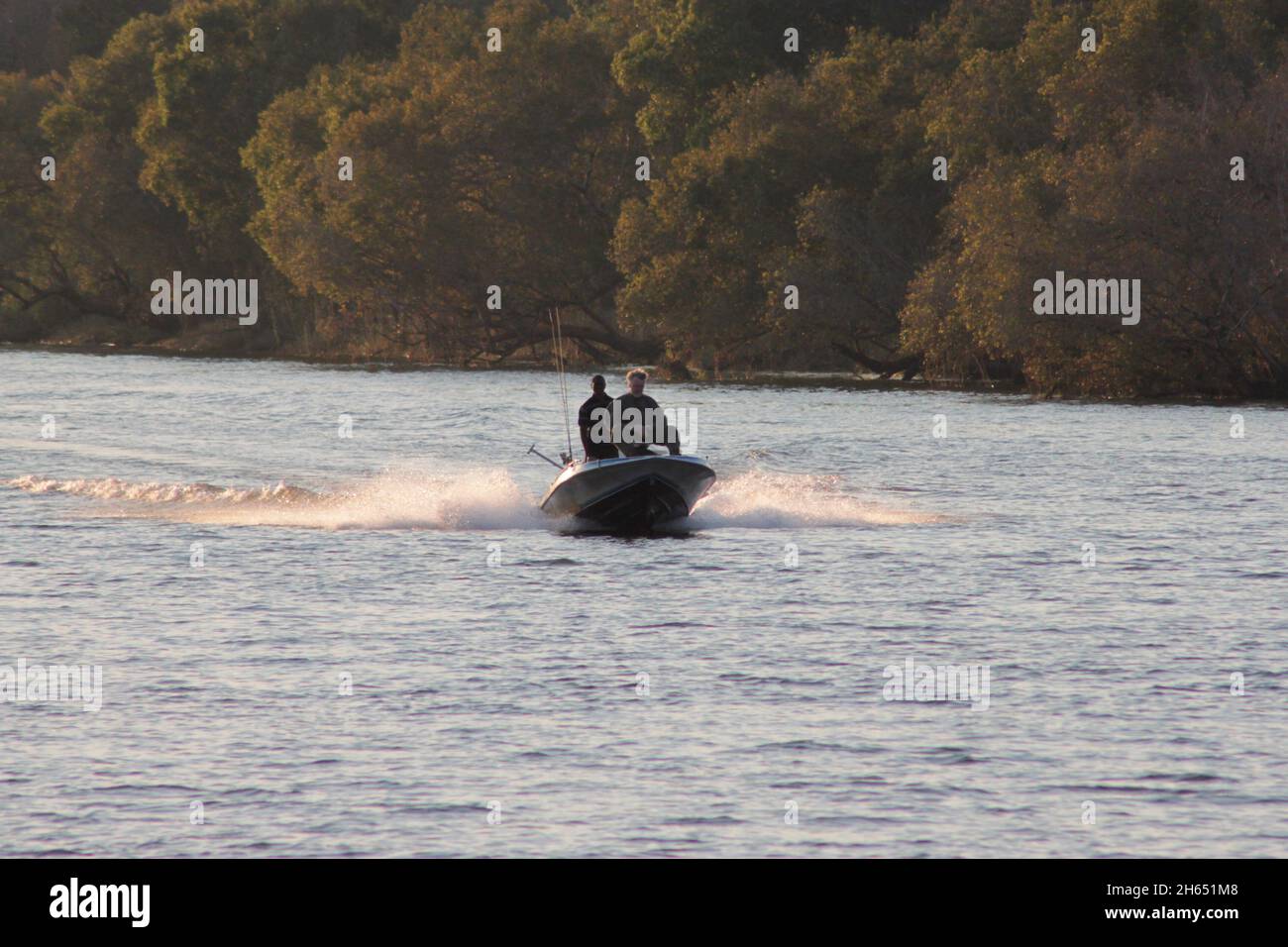 A speedboat is seen cruising on the Zambezi river inVictoria Falls. Water sports are popular in the resort town. Zimbabwe. Stock Photo