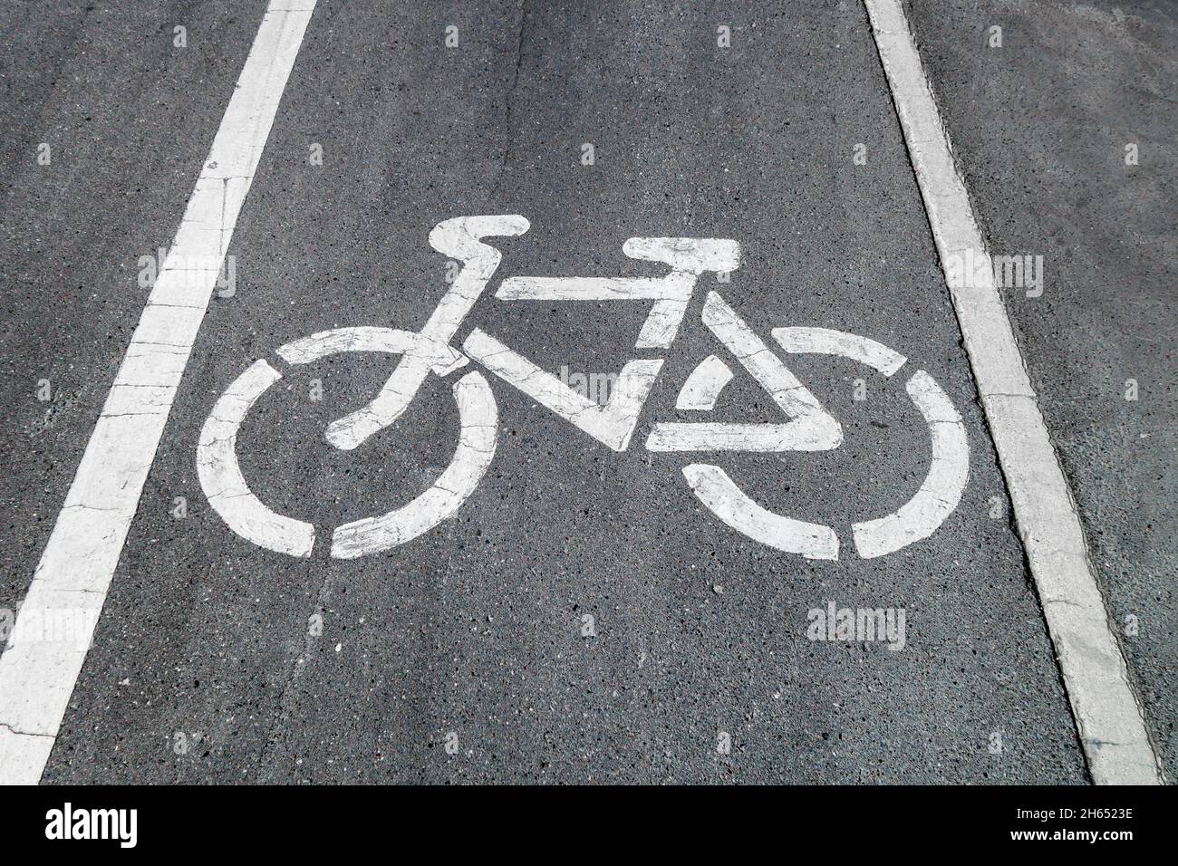 Bicycle painted on asphalt, marking track for cyclists Stock Photo