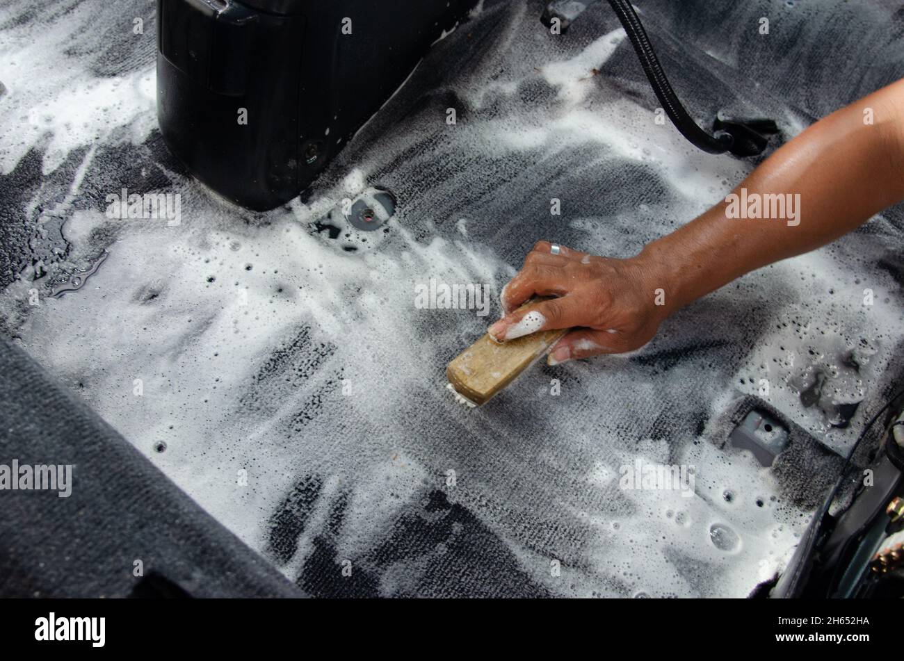 Wash the car carpet.Detailing on interior of modern car.Clean by using