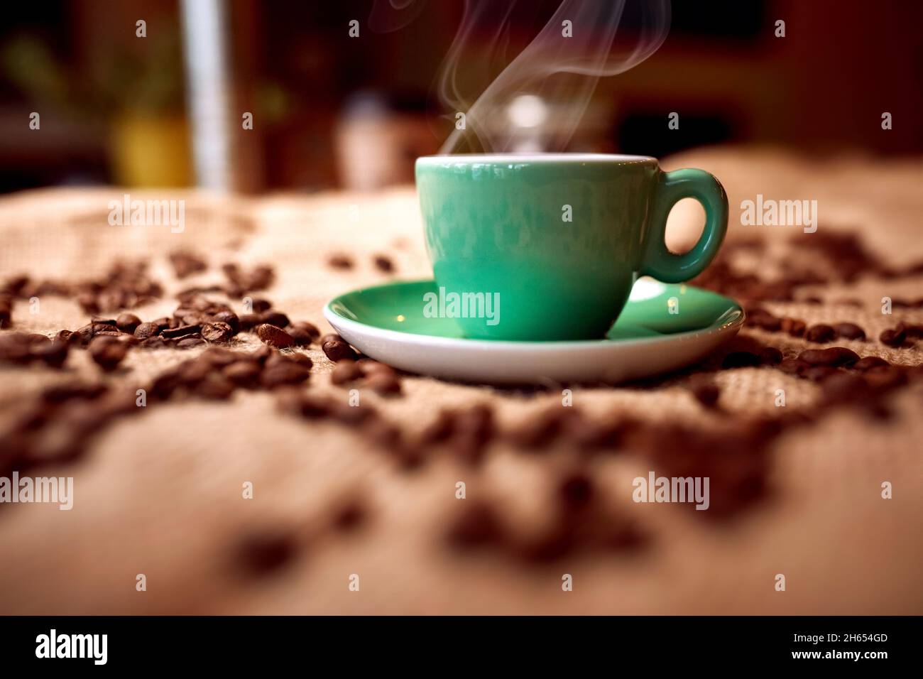 Close-up view of aromatic and fragrant hot coffee cup and coffee beans on the bag. Coffee, beverage Stock Photo