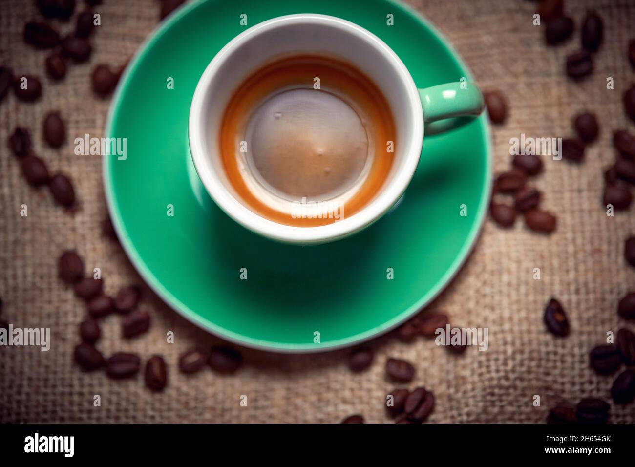 Bird-eye view of cup of aromatic and fragrant coffee standing on the coffee bag. Coffee, beverage Stock Photo