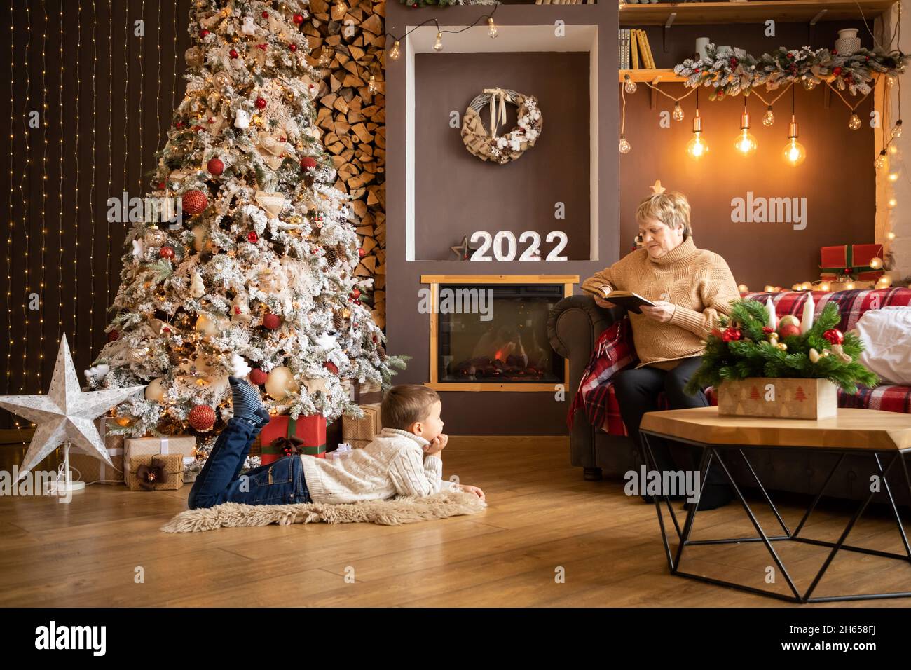 Christmas Eve Readings 2022 Grandmother Reading Book To Grandchildren Near Christmas Tree At Home In  New Year 2022 Stock Photo - Alamy