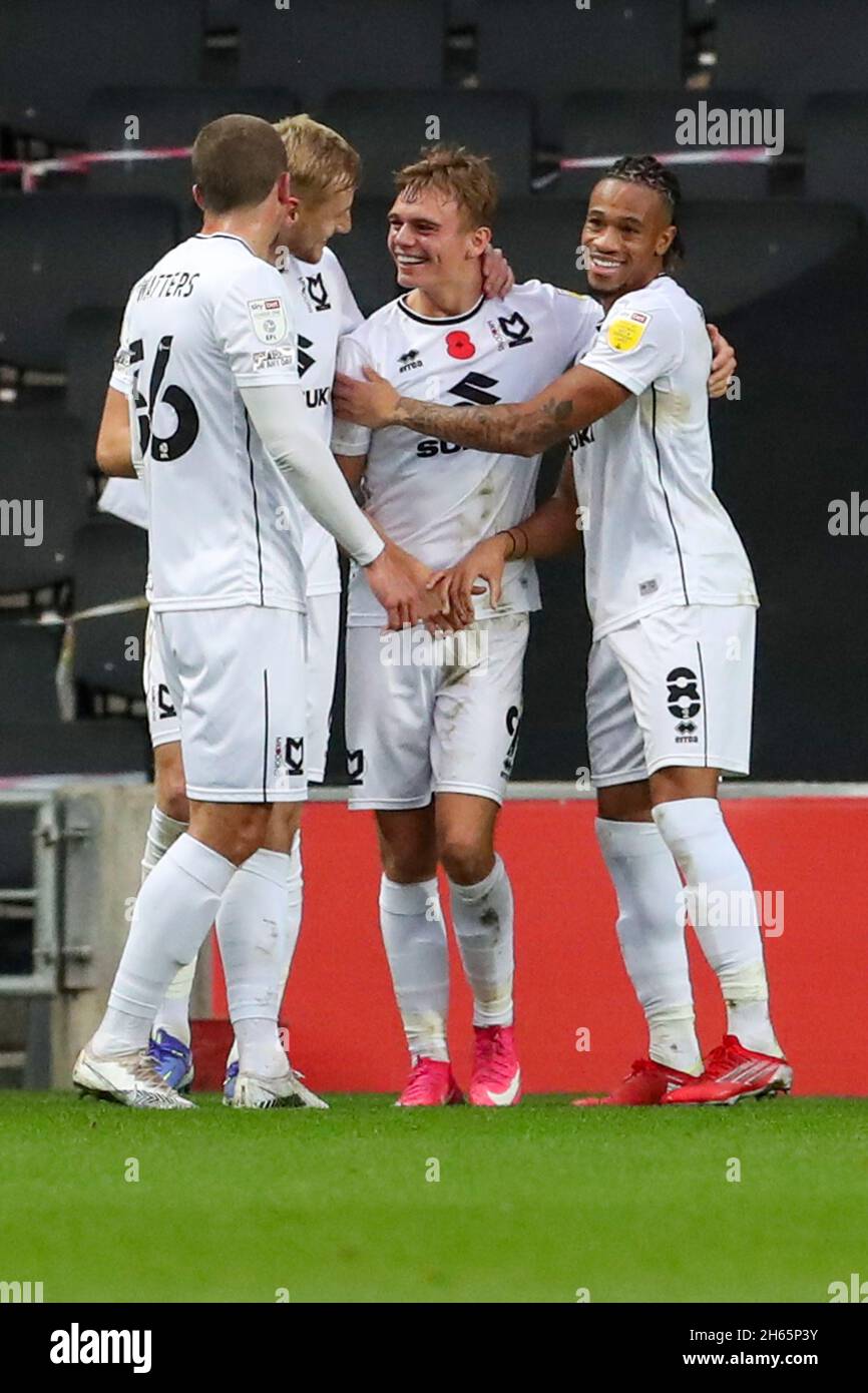 MILTON KEYNES, UK. NOV 13TH Scott Twine celebrates with team mates after scoring for Milton Keynes Dons, to extend their lead making it 3 - 0 against Cambridge United, during the Sky Bet League 1 match between MK Dons and Cambridge United at Stadium MK, Milton Keynes on Saturday 13th November 2021. (Credit: John Cripps | MI News) Credit: MI News & Sport /Alamy Live News Stock Photo