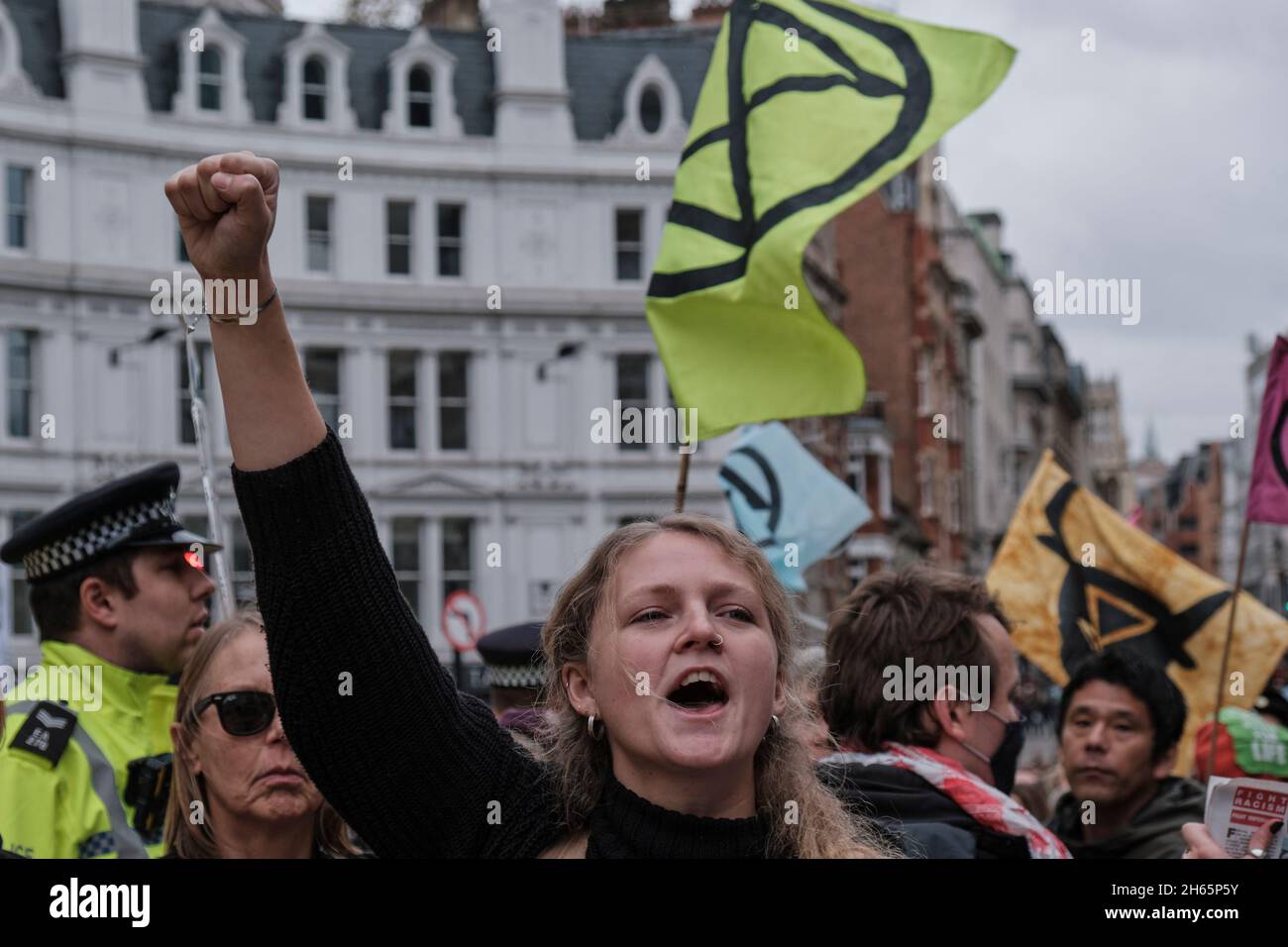 London, UK. 13th Nov, 2021. A young activist is chanting as Extinction Rebellion takes to the streets of London with the Rise and Rebel March to protest for the climate emergency, following COP26 summit. Credit: Chiara Fabbro/Alamy Live News Stock Photo