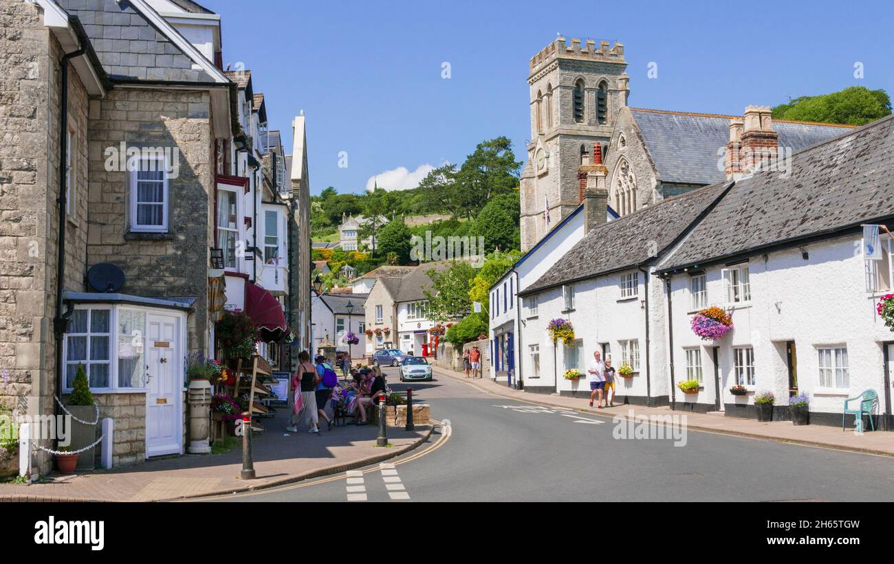 St Michael's Church and other small shops on Fore Street Beer Village centre Beer Devon England UK GB Europe Stock Photo