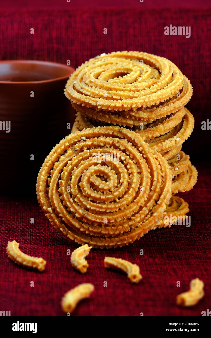 Indian Traditional Snack Chakli, a spiral shaped, Chakali or murukku Indian Traditional Tea Time Snack, Traditional Diwali festival snacks in India. Stock Photo