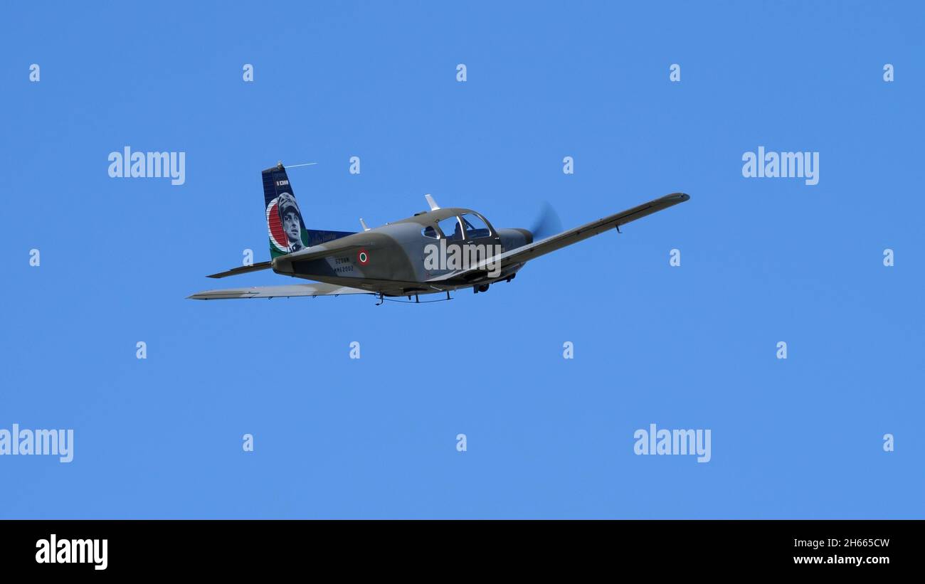 Rivolto del Friuli, Udine, Italy SEPTEMBER, 17, 2021 Green and brown military propeller plane in flight in the blue sky. SIAI Marchetti S.208 of Italian Air Force Stock Photo