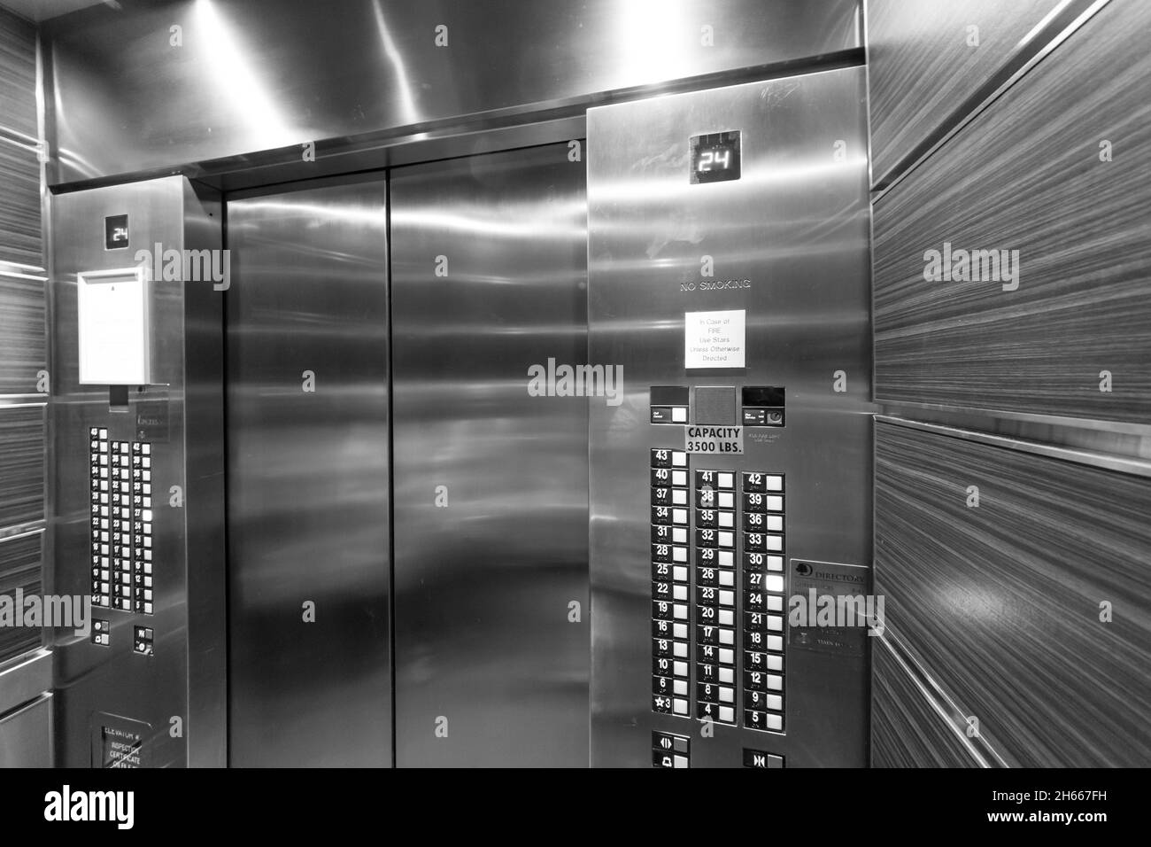 Black and white wide shot inside elevator Stock Photo