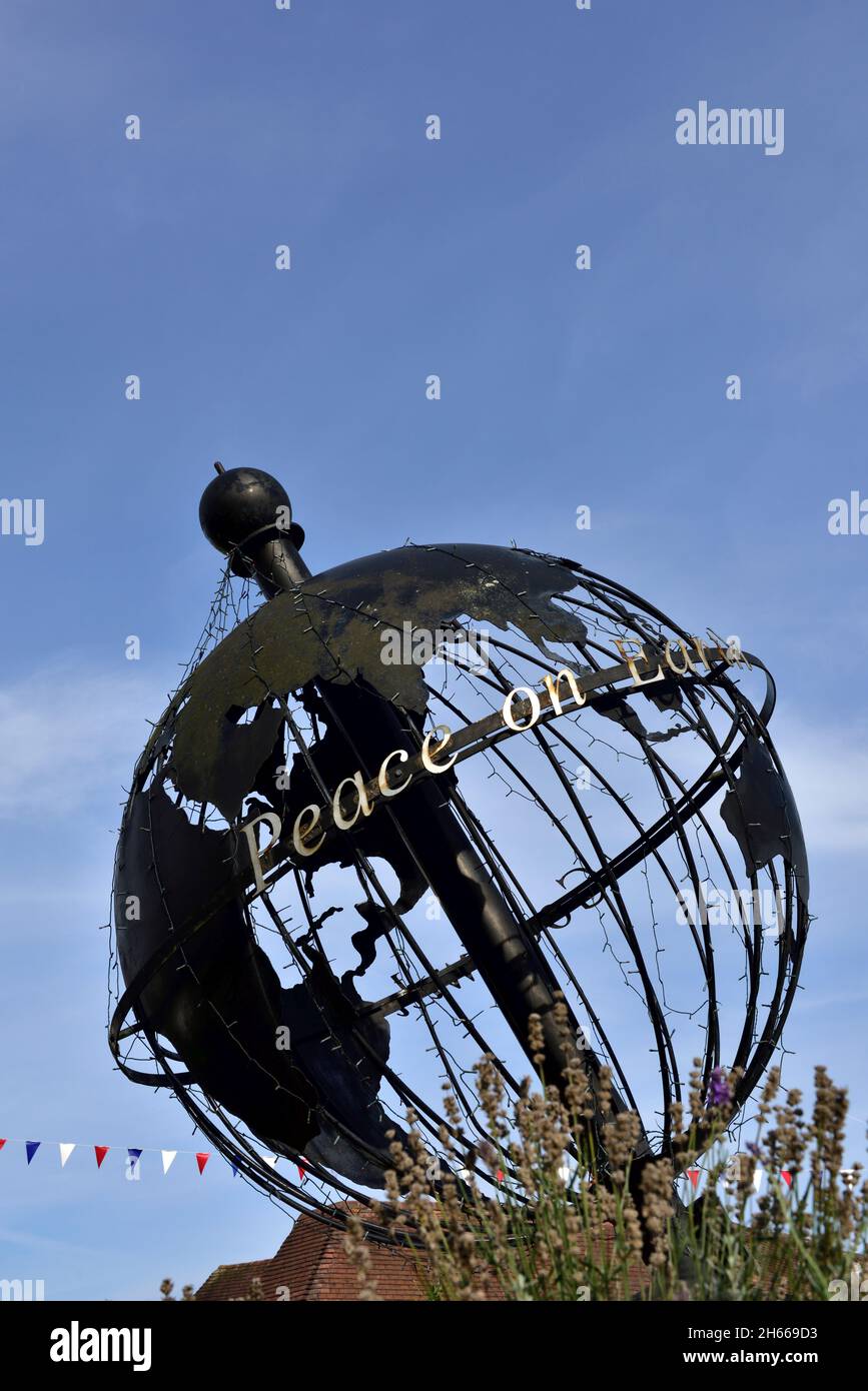Sculptural world globe with “Peace on Earth” Stock Photo