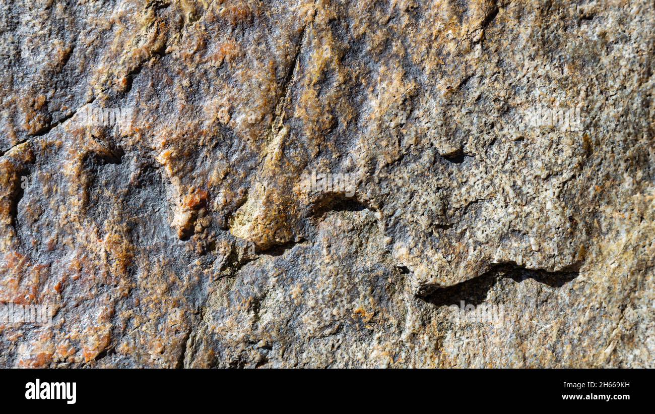 Granite rock texture. Cracked granite surface from weathering. Closeup