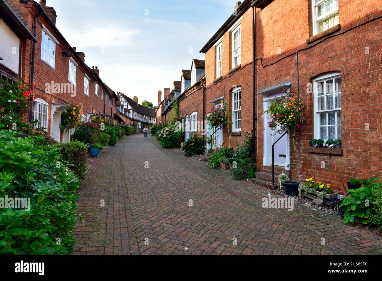 Modern brick built terraced housing development along brick paved ...