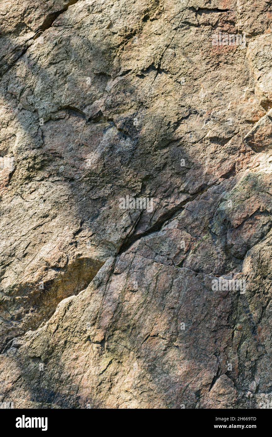 Granite rock texture. Cracked granite surface from weathering. Closeup