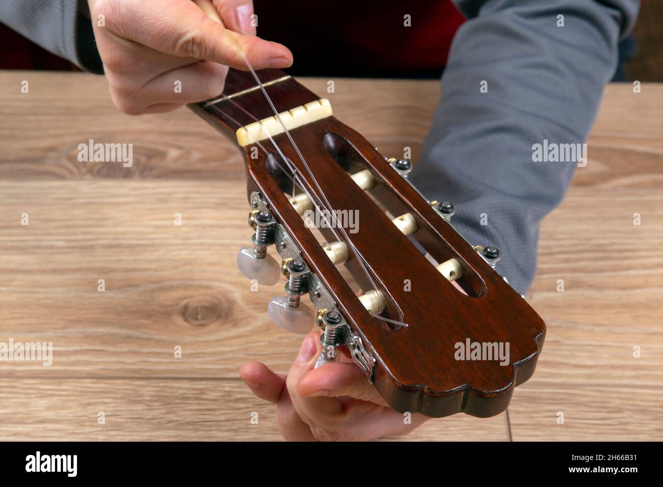 replacement and insertion of nylon strings in a classical guitar