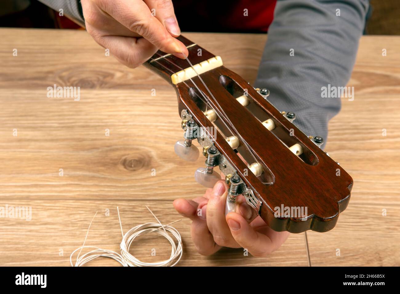 Changing nylon strings on a sixstring classical guitar. instruction