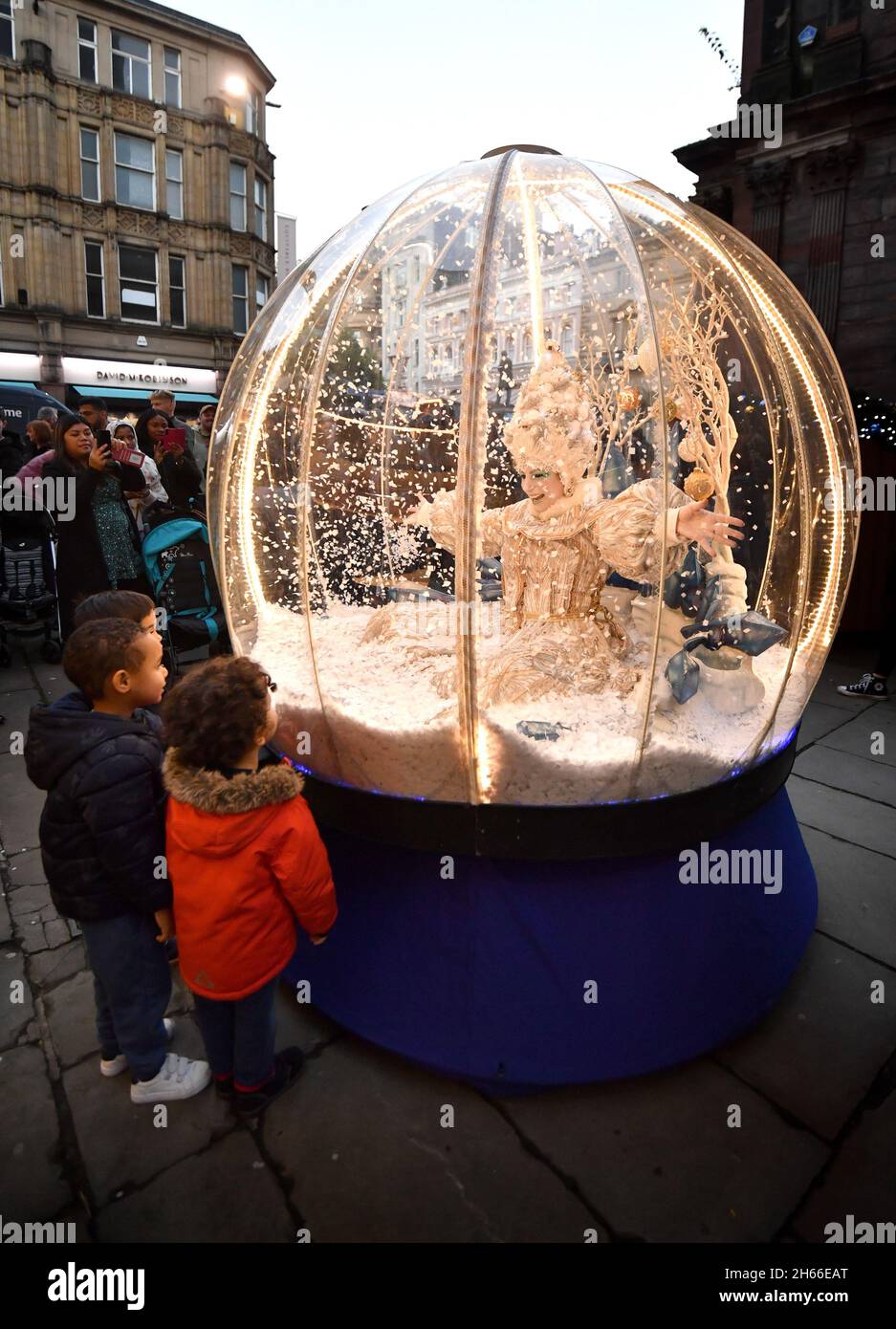 EDITORIAL USE ONLY Children view the Snow Globe Queen during the launch of the First Day of Christmas event, in St Ann's Square, organised by Manchester Business Improvement District. Picture date: Saturday November 13, 2021. Stock Photo