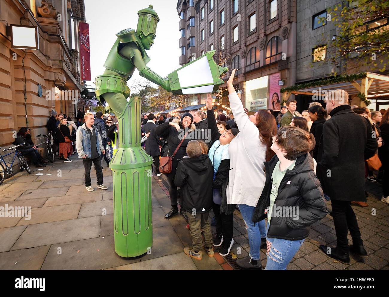 EDITORIAL USE ONLY Members of the public react to the Living Lamp-posts during the launch of the First Day of Christmas event, in St Ann's Square, organised by Manchester Business Improvement District. Picture date: Saturday November 13, 2021. Stock Photo