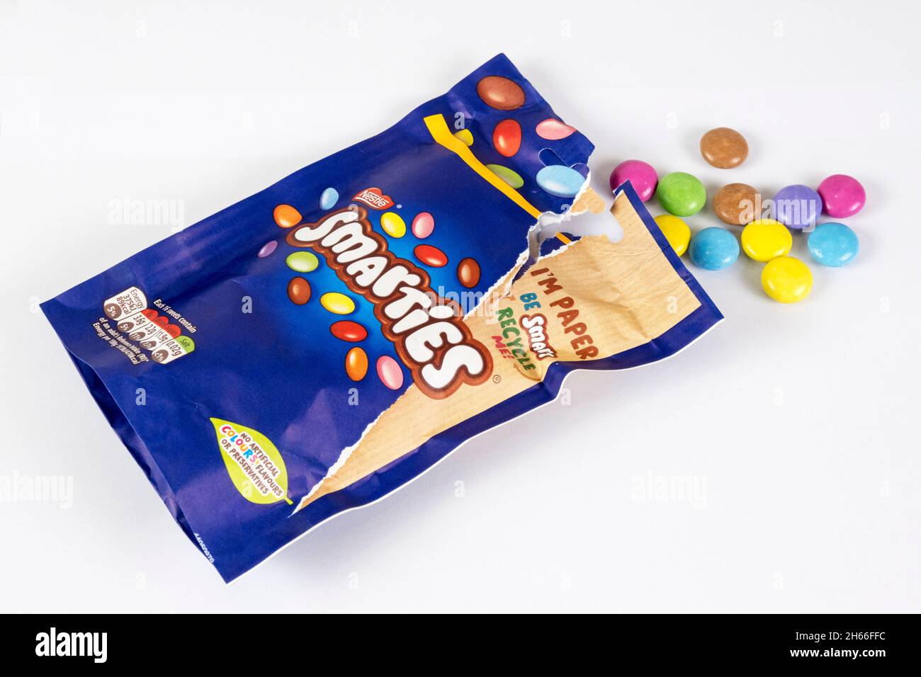 An opened recyclable paper bag of Smarties chocolate covered sweets made by Nestlé. Stock Photo