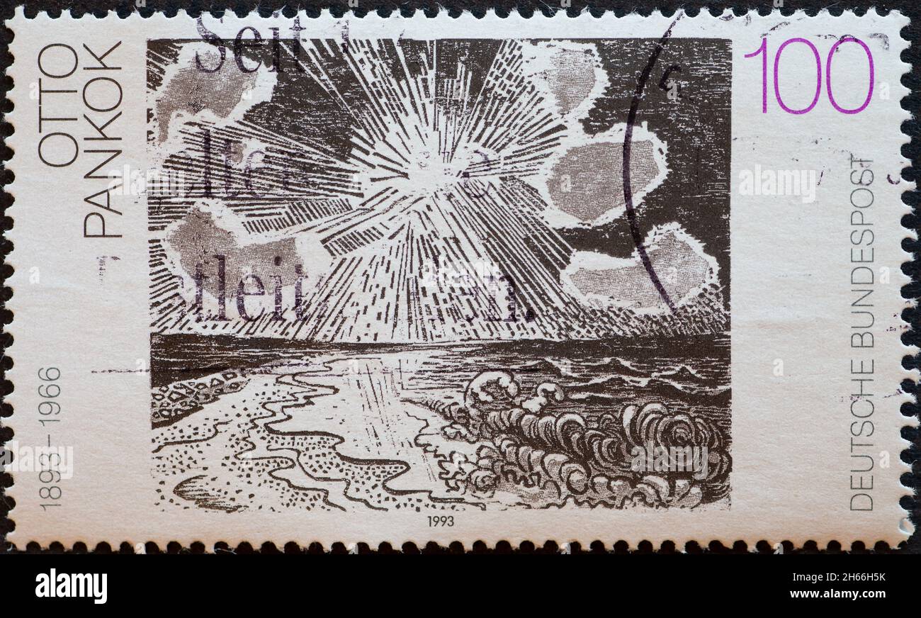 GERMANY - CIRCA 1993 : a postage stamp from Germany, showing a painting with sea and sun by the painter Otto Pankok. German painting of the 20th centu Stock Photo