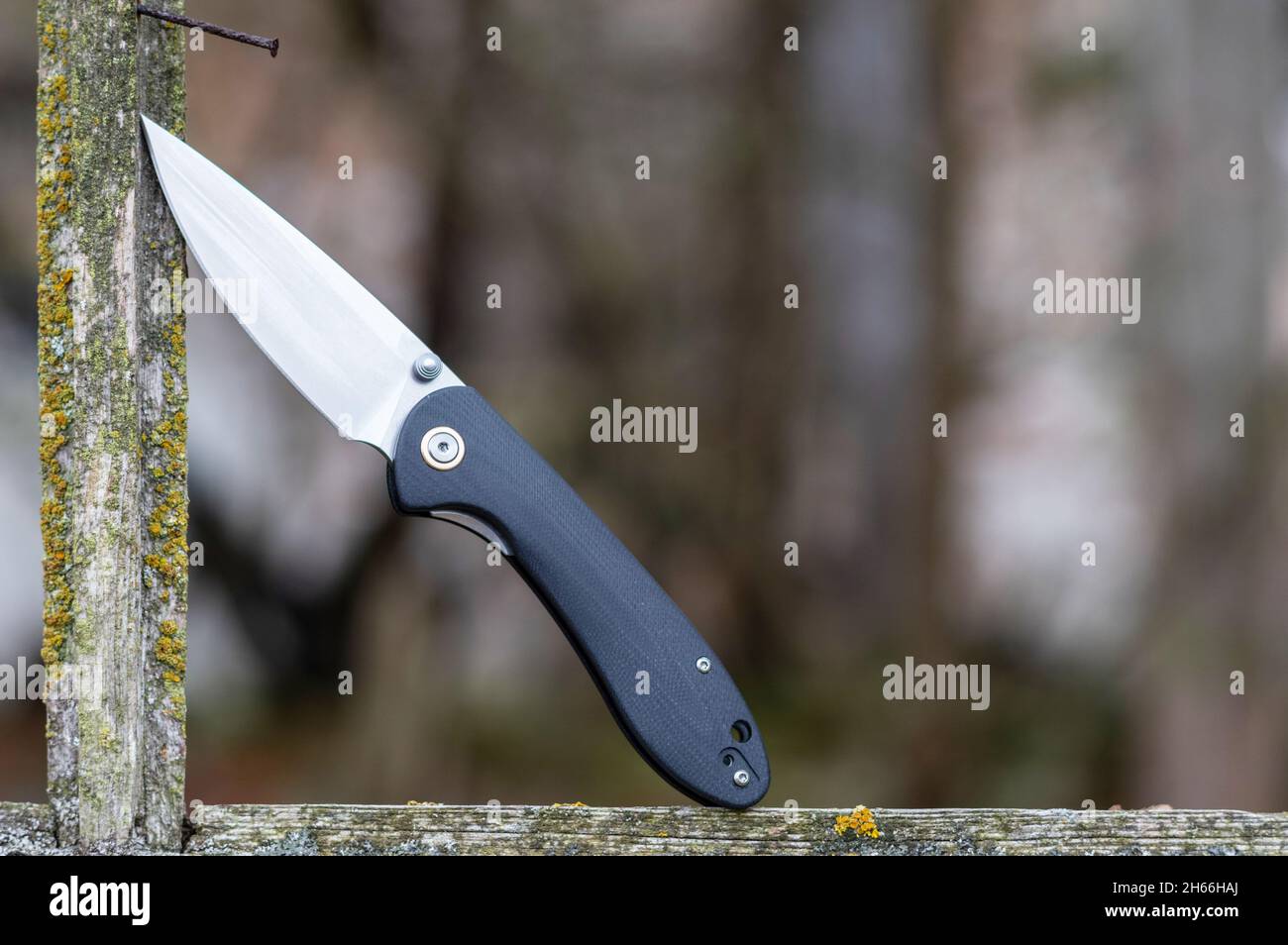 Knife in the window frame. Knife in a wooden frame. Plastic knife with