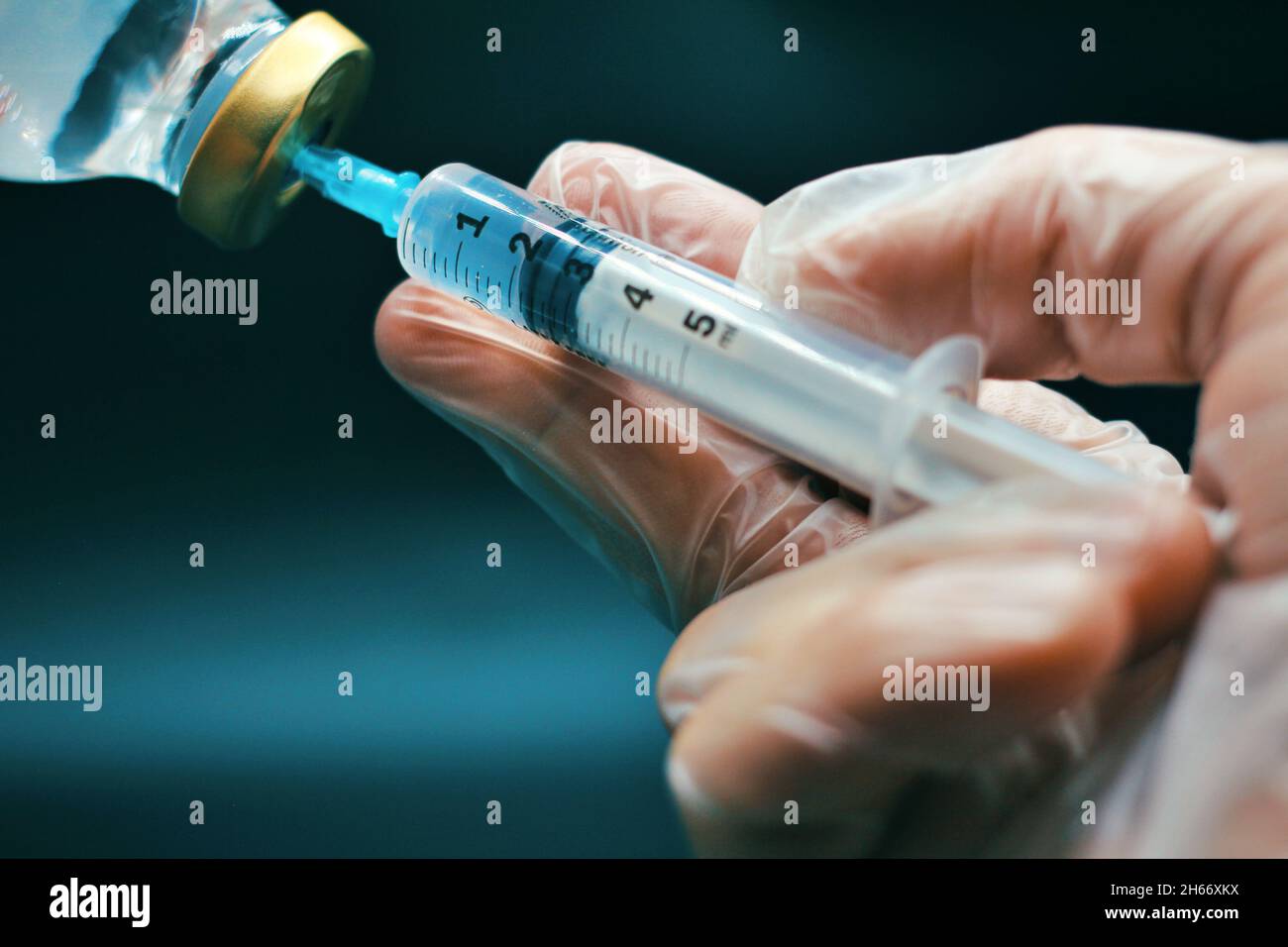Doctor wearing latex glove in a lab while preparing an injection Stock