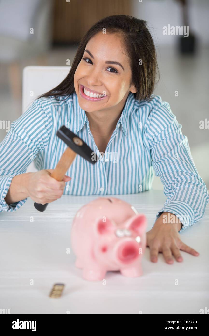 woman is breaking piggy money bank Stock Photo Alamy