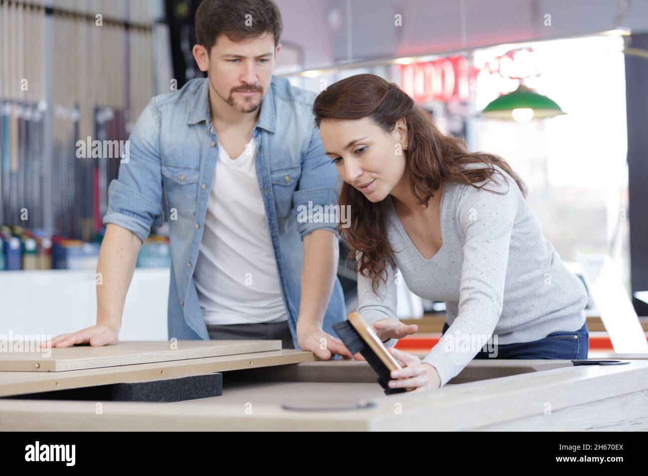 man and woman brushing surface of snooker pool billards table Stock