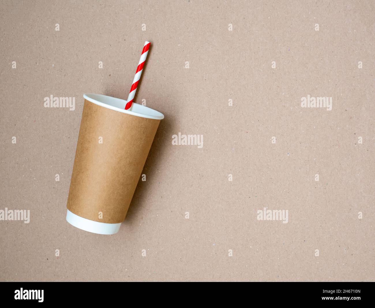 https://c8.alamy.com/comp/2H6710N/takeaway-coffee-mug-with-paper-white-and-red-drinking-straw-on-craft-paper-background-the-concept-of-a-world-without-plastic-and-a-clean-planet-2H6710N.jpg