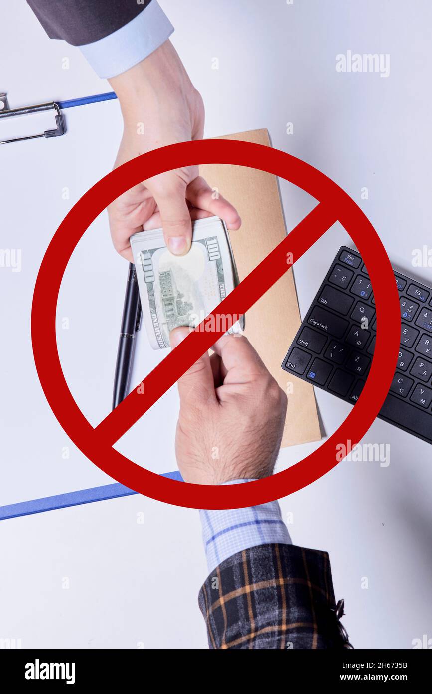 Stop corruption, bribery concepts. Giving money or bribe for signing agreement. Symbol of anti-corruption movement, lobbying, extortion and nepotism Stock Photo