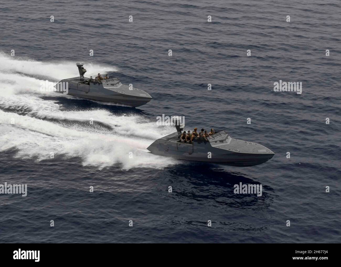 Mediterranean Sea, United States. 26 May, 2021. U.S. Navy SEALS combatant craft assault crafts, assigned to the Special Boat Team Twenty, speed alongside the Expeditionary Sea Base USS Hershel Woody Williams May 26, 2021 in the Mediterranean Sea. Credit: MC2 Eric Coffer/U.S. Navy/Alamy Live News Stock Photo