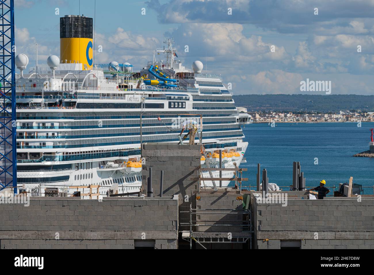 Palma de Mallorca, Balearic Islands, Spain - 11 04 2021: Residential building under construction in Palma port with a cruise ship on the background Stock Photo