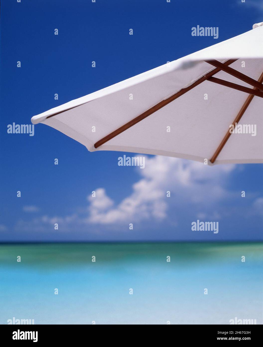Beach umbrella and the Caribbean Sea as seen from the Turks and Caicos Islands sunny warm tropical holidays Stock Photo
