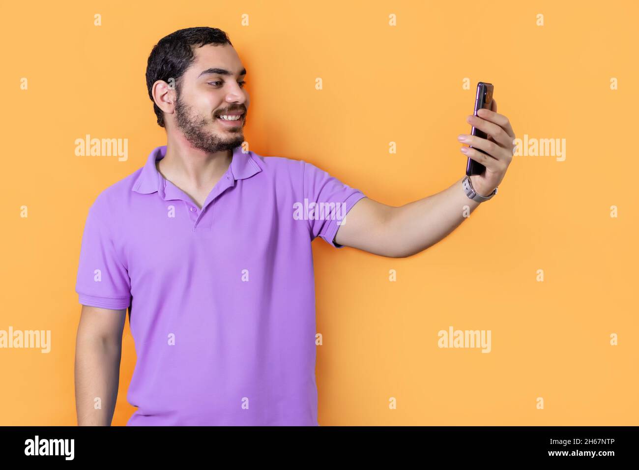 Bearded man, smiling and taking a selfie with his smartphone in the ...