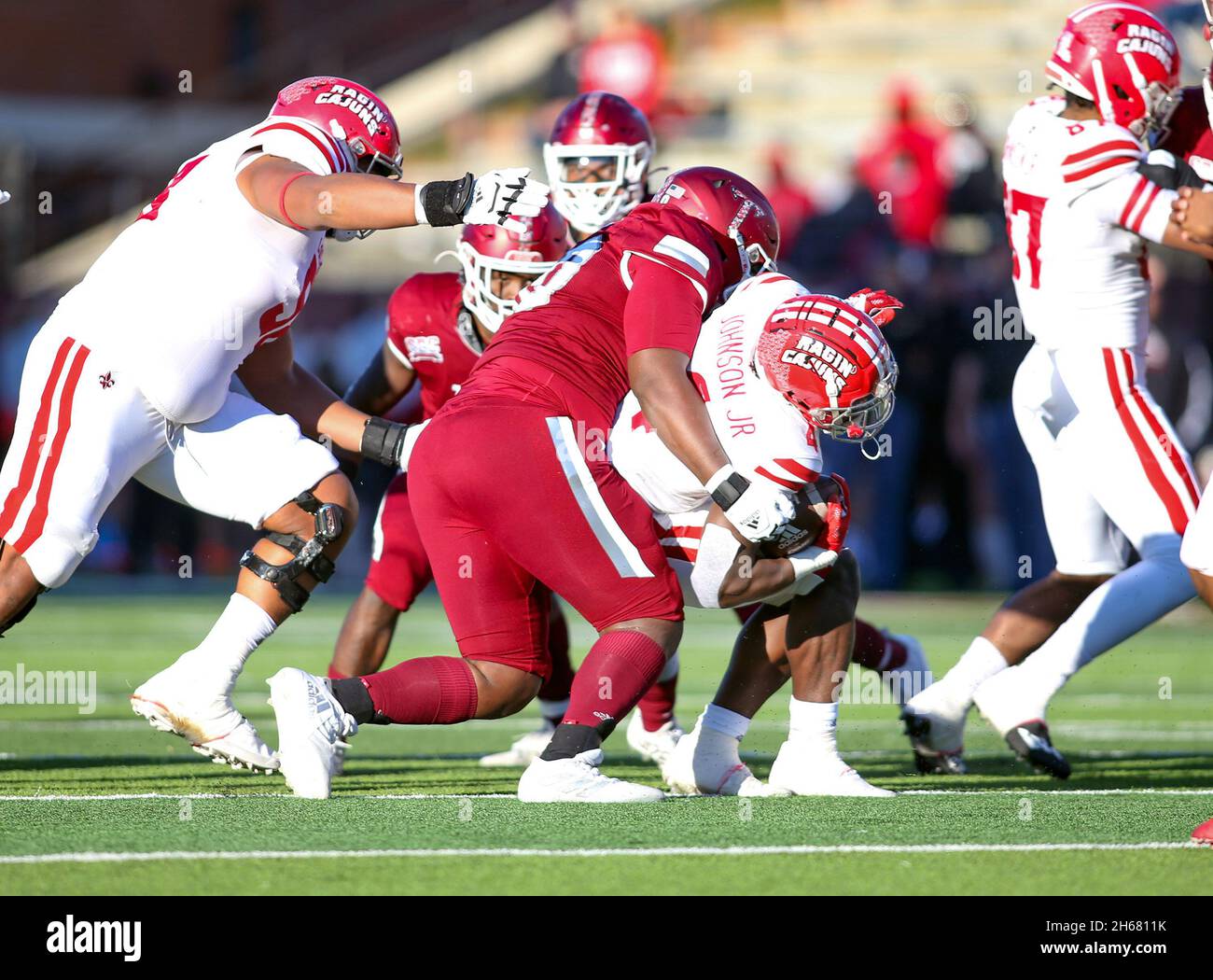 Troy, Alabama, USA. 13th Nov, 2021. Troy Trojans defensive tackle Elgin Griffin (90) brings down Louisiana-Lafayette Ragin Cajuns running back Montrell Johnson (4) during an NCAA football game between the Troy Trojans and the Louisiana-Lafayette Ragin Cajuns at Veterans Memorial Stadium in Troy, Alabama. Louisiana-Lafayette defeated Troy 35-21. Brandon Sumrall/CSM/Alamy Live News Stock Photo