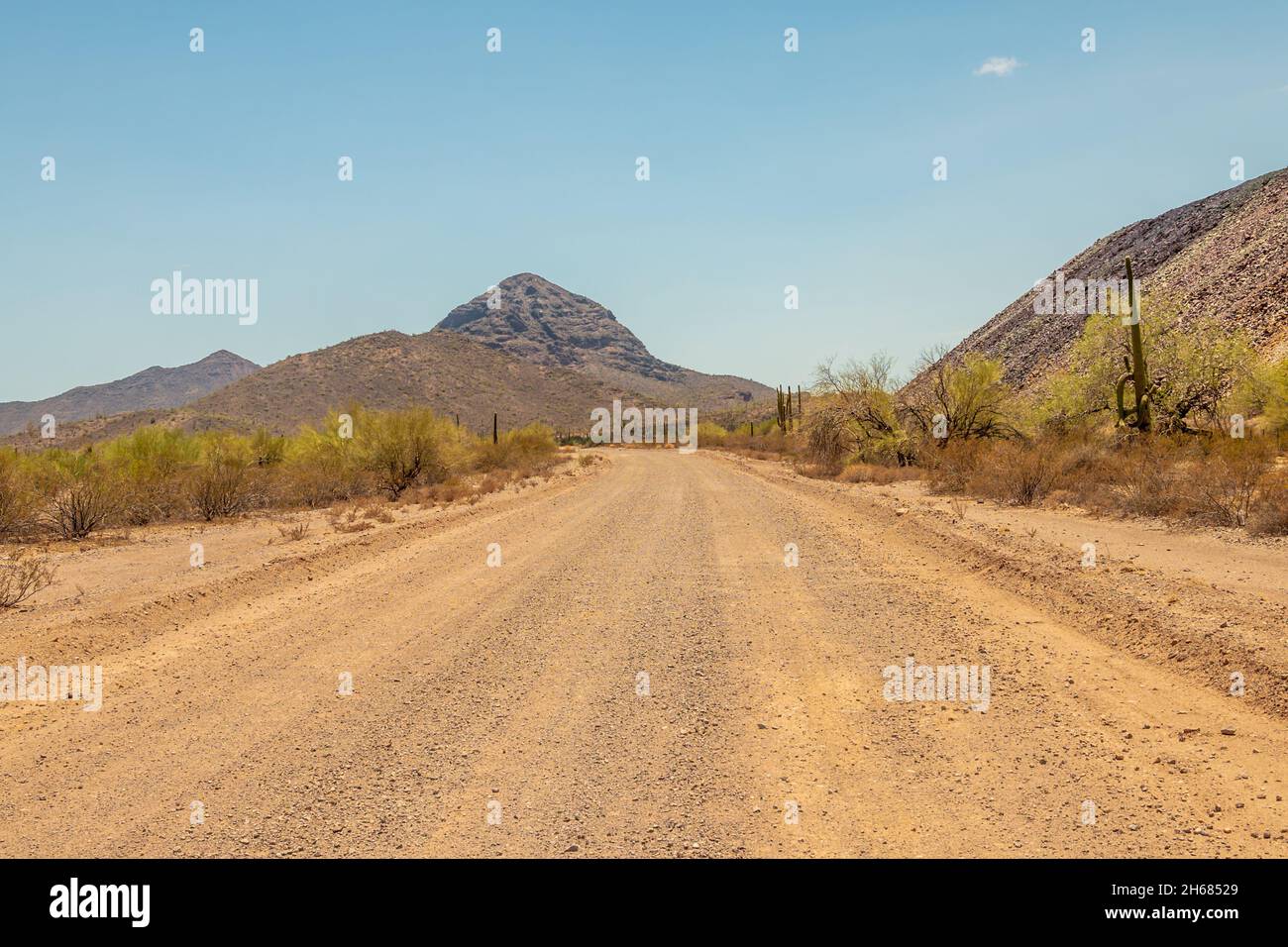 Dusty road leading to a mountain in Arizona Stock Photo