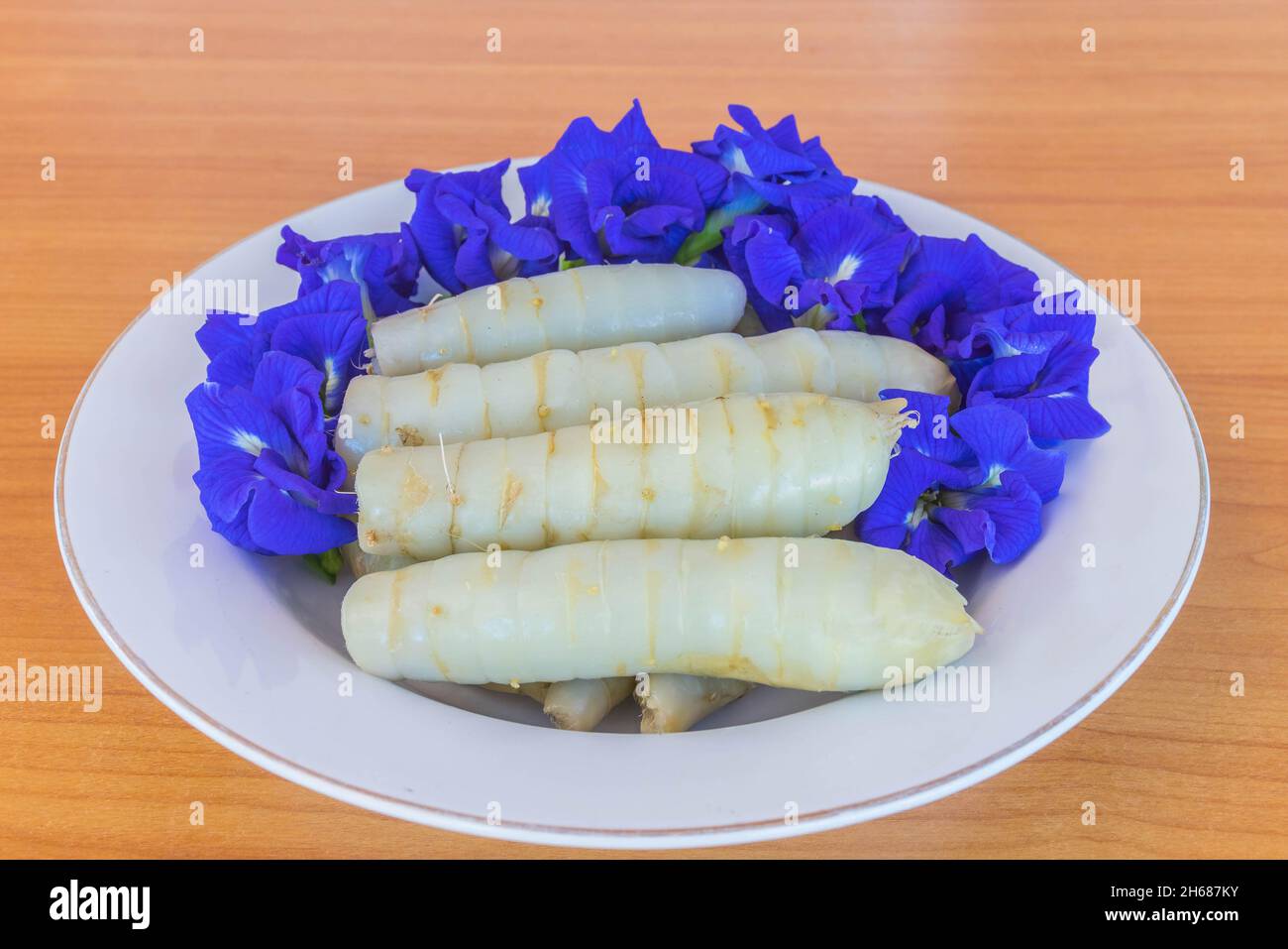 West Indian Arrowroot,Maranta arundinacea,Canna indica,Australian arrowroot with Blue Pea, Butterfly Pea,flower,Thailand herb on the plate. Stock Photo