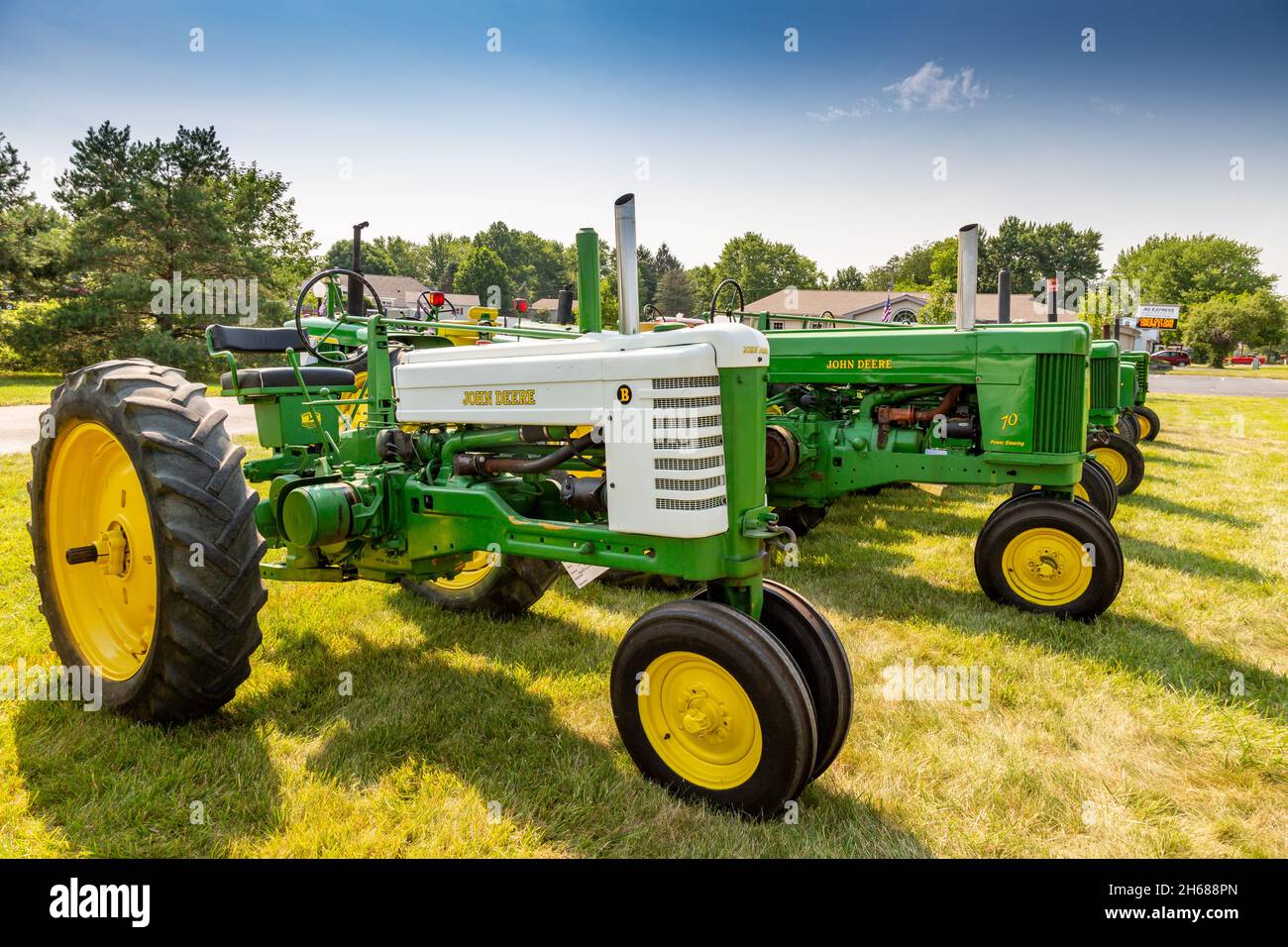 A model B and a model 70 lead a line of antique John Deere farm tractors at a tractor show in Warren, Indiana, USA. Stock Photo