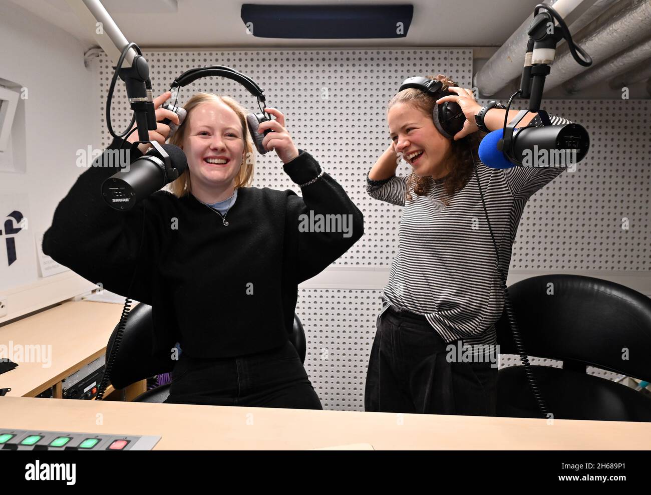 Ilmenau, Germany. 04th Nov, 2021. Eva Seidl (l) and Franziska Wehr (r) are  at the microphones during the weekly morning show at Germany's oldest  student radio station. More than 40 young people