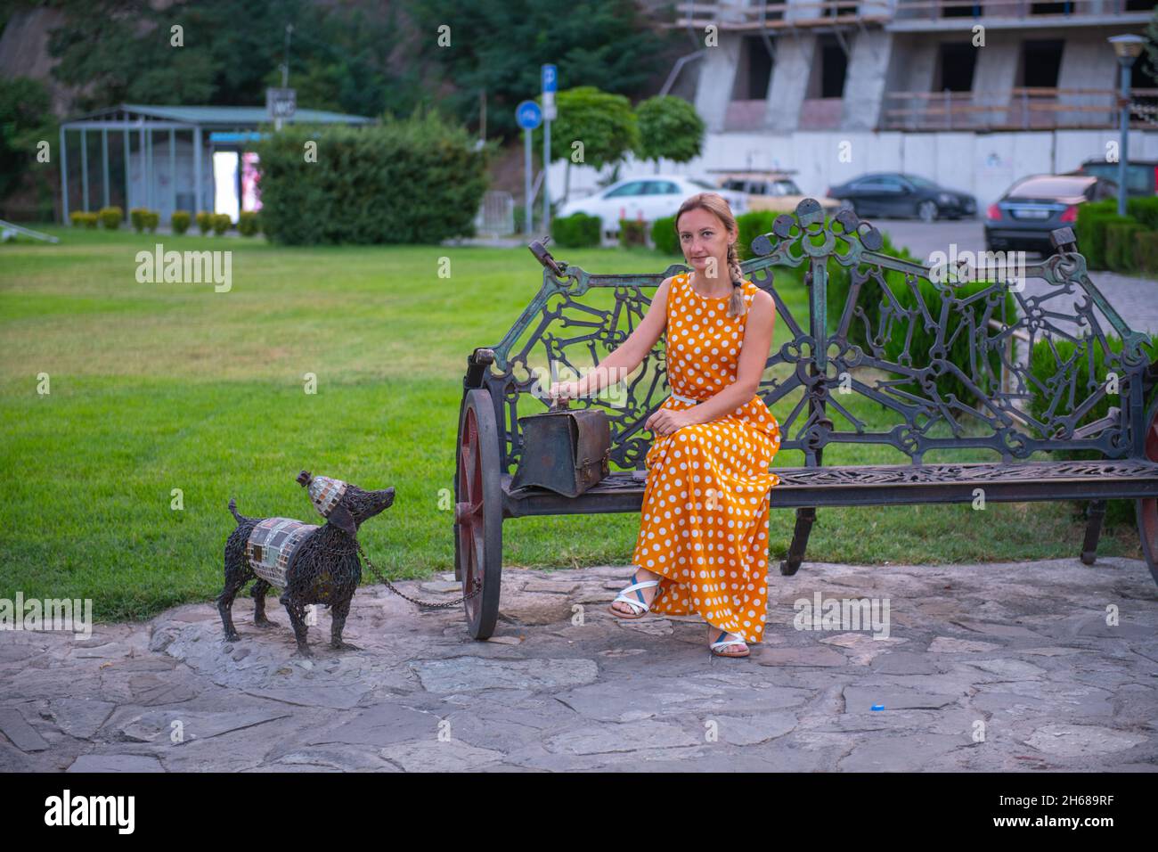 girl sitting on a metal bench with a dog Stock Photo - Alamy