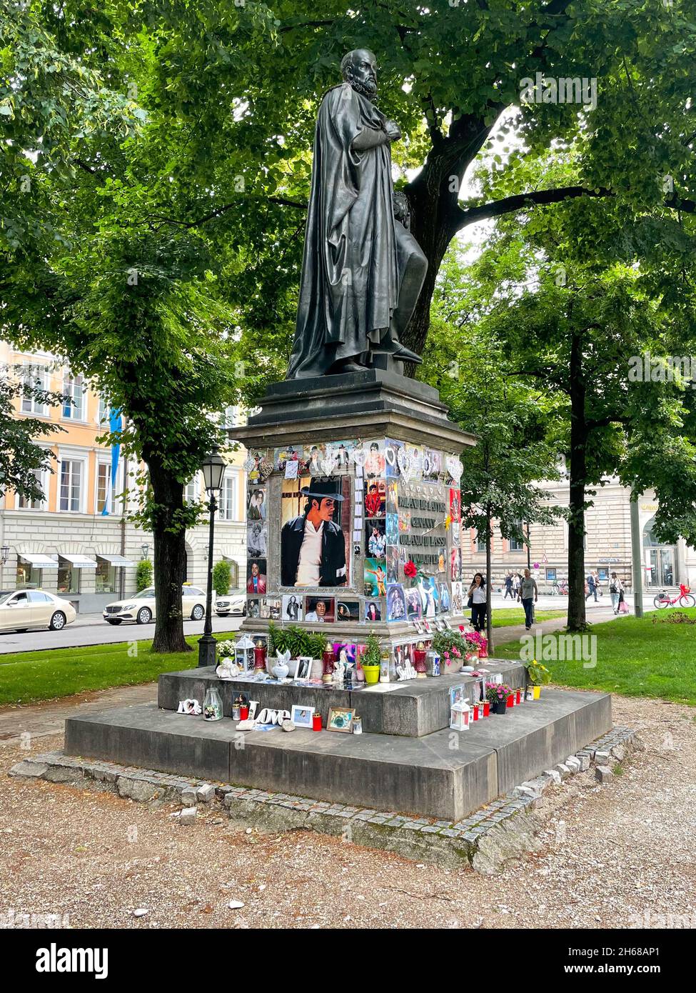 Munich, Germany - July 8, 2021: Souvenirs of Michael Jackson placed around a statue at Promenadenplatz. Stock Photo