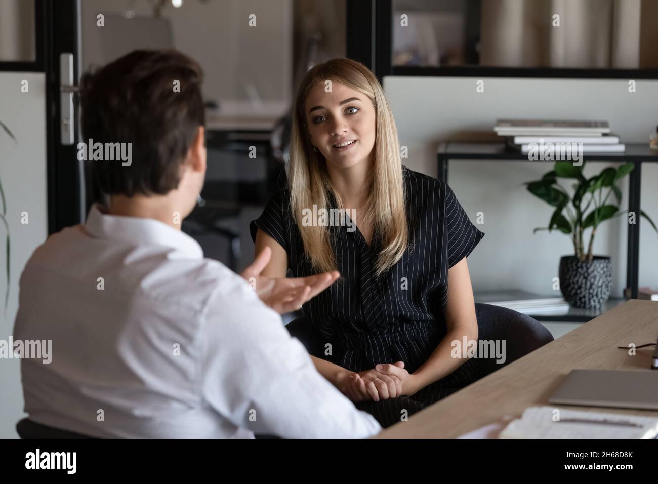 Happy two colleagues briefing new project ideas. Stock Photo