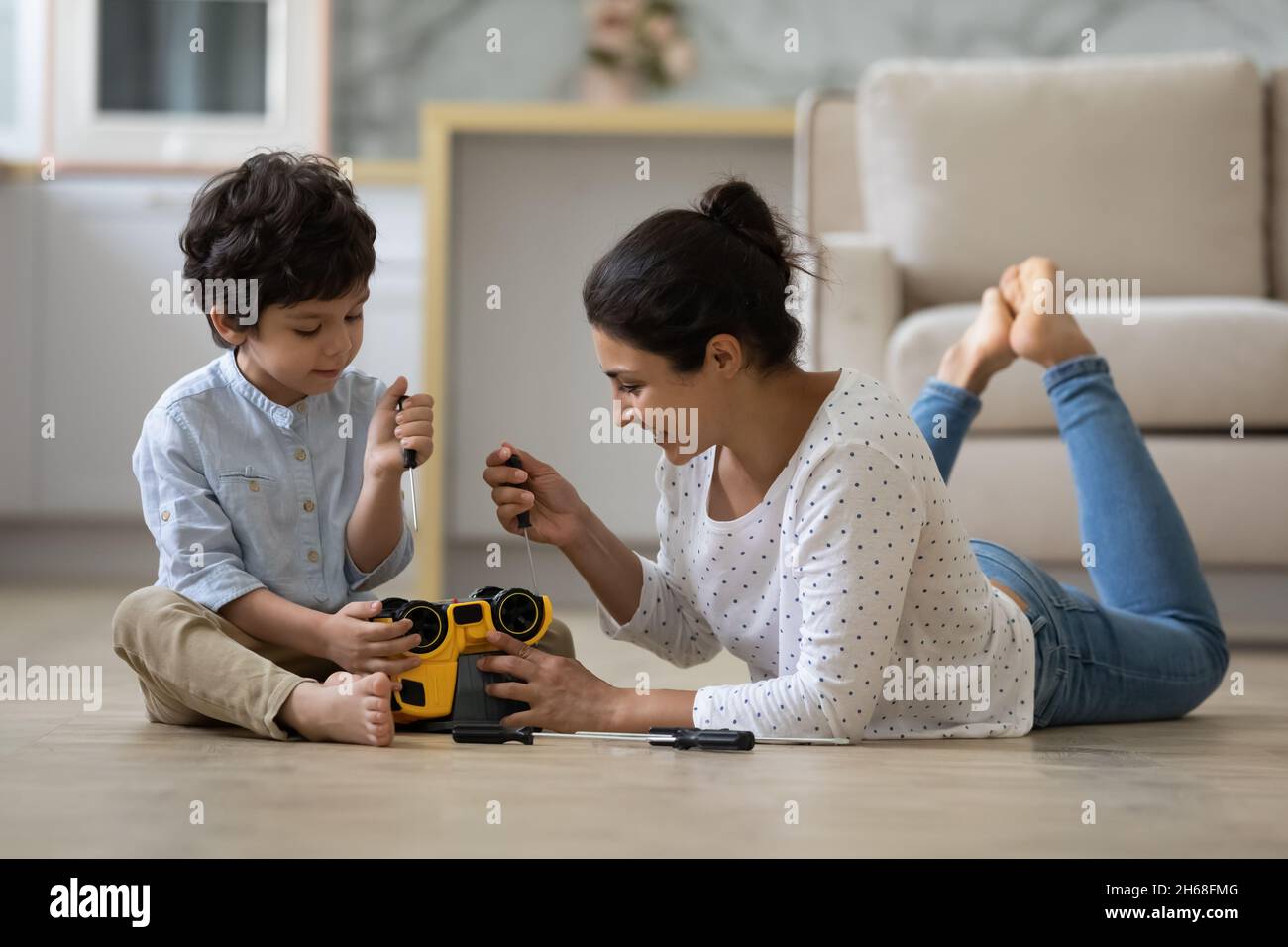Happy Indian mom and little son playing motor mechanic games Stock Photo