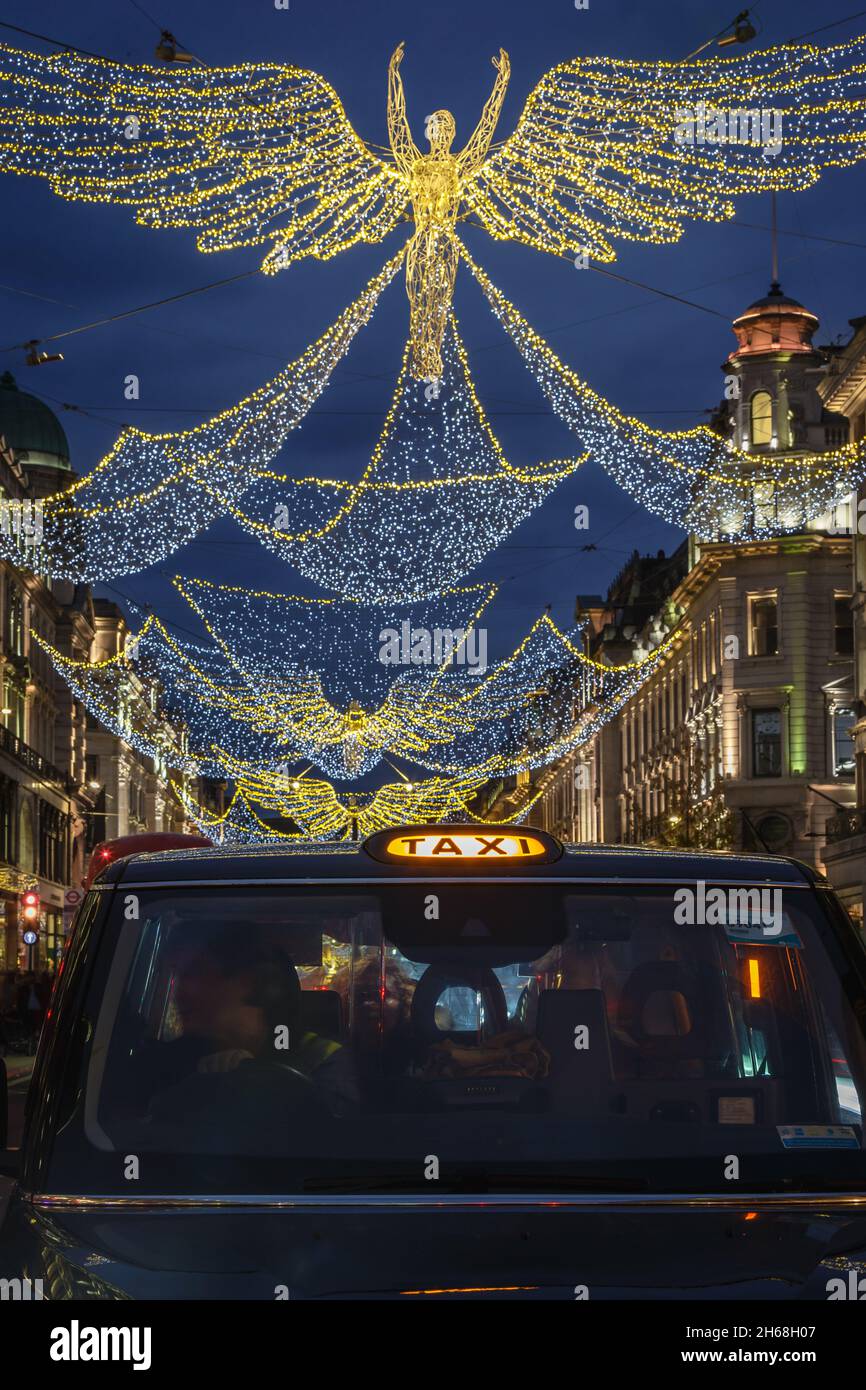 Christmas Lights above a taxi on London's famous Regent Street Stock