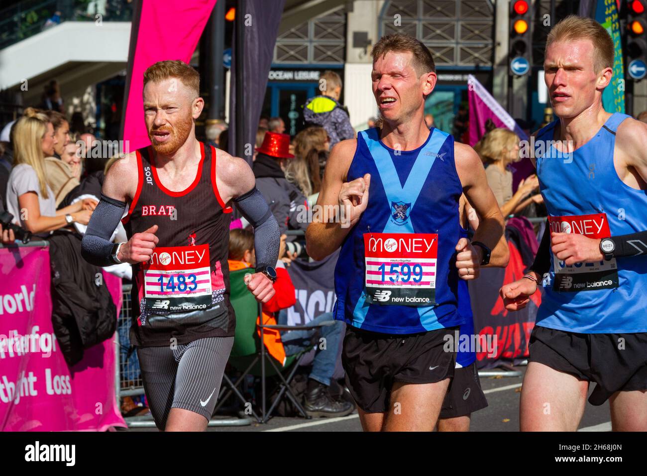 3 men running, Virgin Money London Marathon 2021 at the 25 mile point, Victoria Embankment. Stock Photo