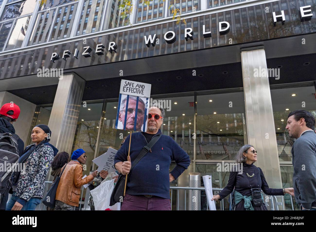Pfizer Protest New York, United States. 13th Nov, 2021. A man holds a placard as city ...