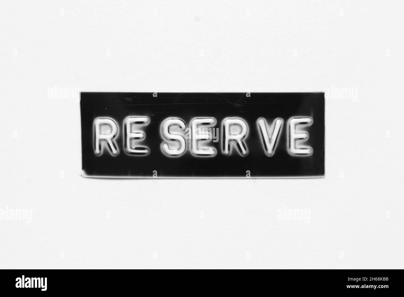 Black color banner that have embossed letter with word reserve on white paper background Stock Photo