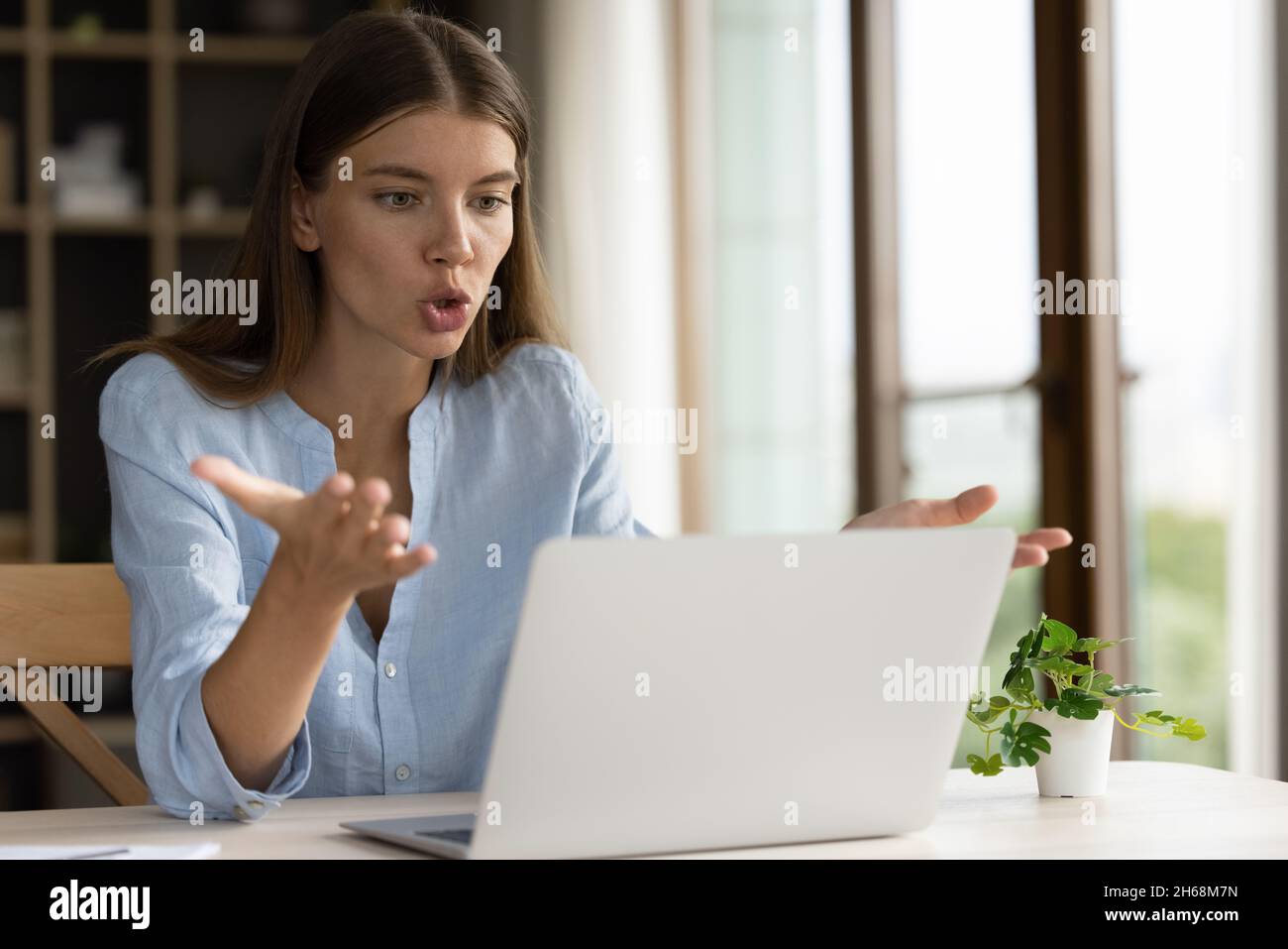 Anxious stressed millennial business woman looking at laptop screen. Stock Photo