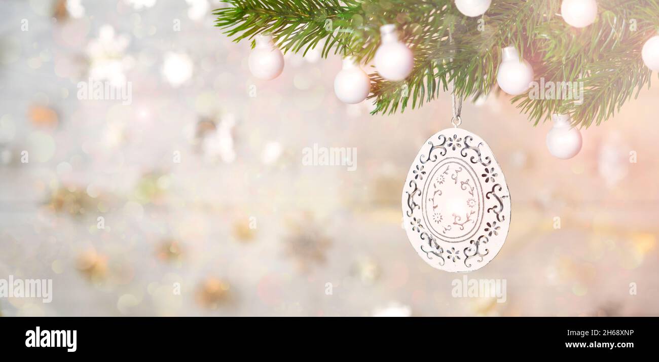 White Christmas decoration on tree and blurred background in gold color. Stock Photo